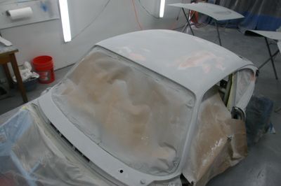 A white car is being painted