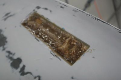 A piece of wood is sitting on top of a white surface