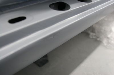 A close up of a piece of metal with holes in it