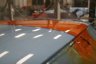 A close up of the roof of a blue and orange car