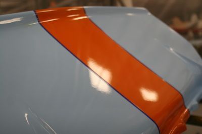 A close up of a blue and orange stripe on a car