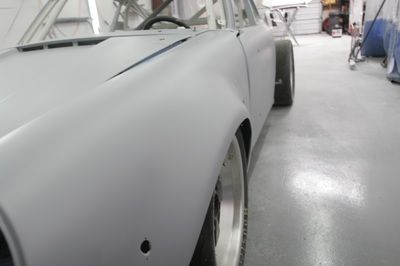 A white car is being painted