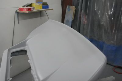 A white plastic container is sitting on a table in a room