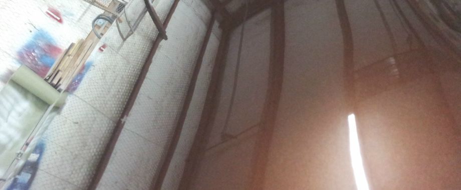 A light is shining through a window in a dark room