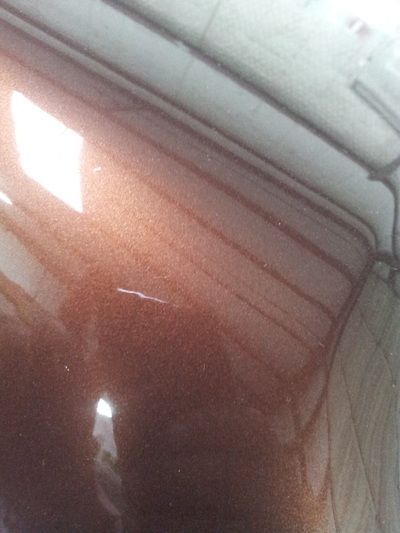 A close up of a garage door with a light shining through it