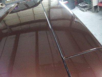 A close up of the hood of a brown car