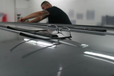 A pair of glasses is sitting on the roof of a car