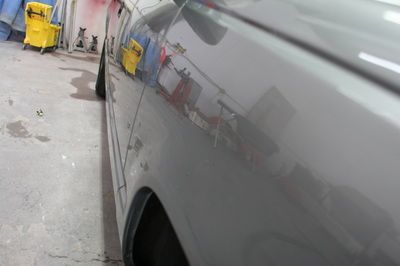 A close up of a car 's side in a garage
