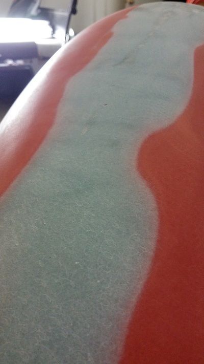 A close up of a piece of paper on a red surface