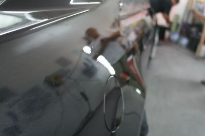 A close up of a car door in a garage