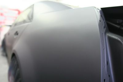 A close up of the side of a car with a door open