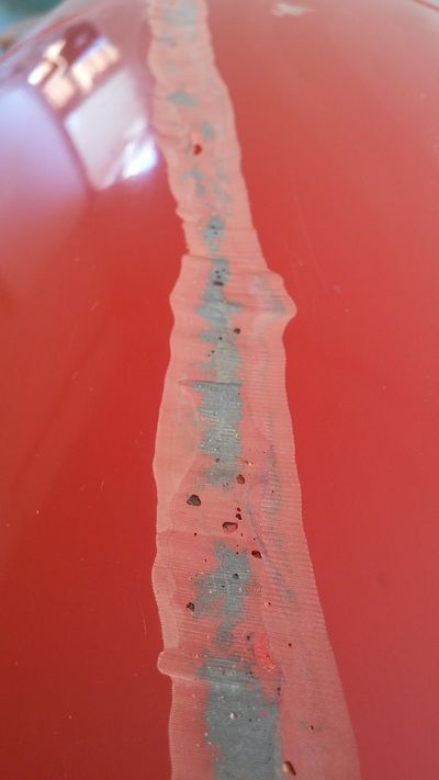 A close up of a piece of paper on a red surface