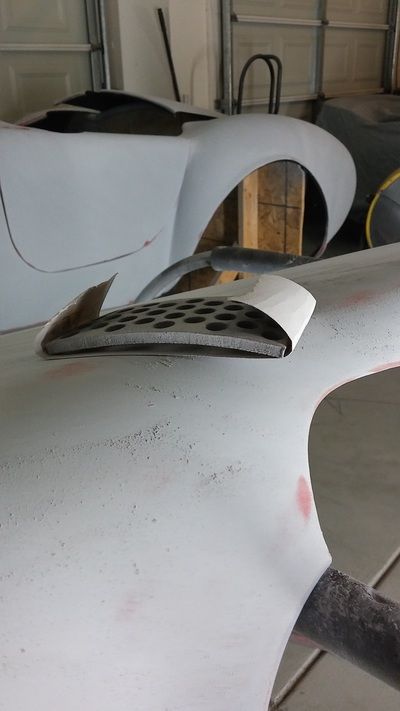 A close up of a car body in a garage