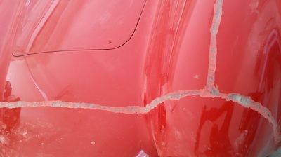 A close up of a red plastic bag with a hole in it