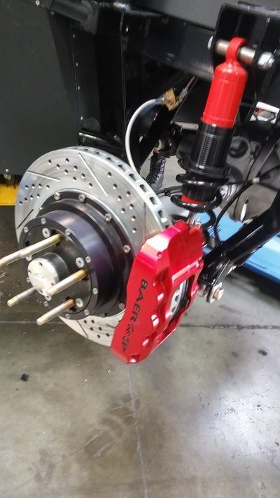 A close up of a red brake caliper on a car
