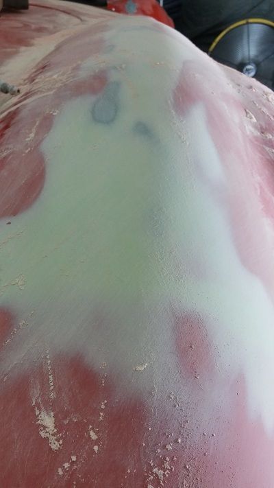 A close up of a red surface with white powder on it