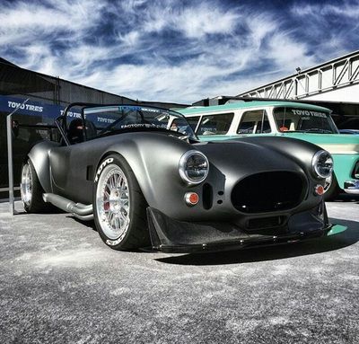 A black sports car is parked in front of a building