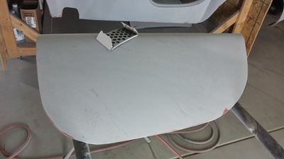 A piece of metal is sitting on top of a wooden table