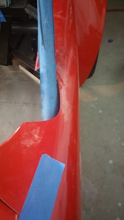 A close up of a red object with blue tape on it