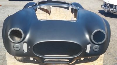 A black car is sitting on a wooden pallet