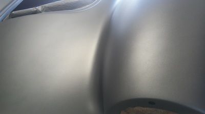 A close up of a gray fender on a car