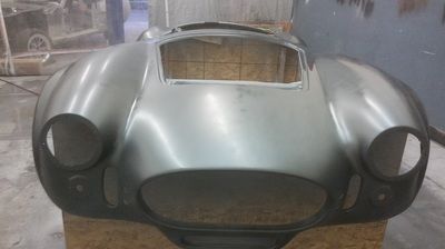 A silver car bumper is sitting on top of a wooden box