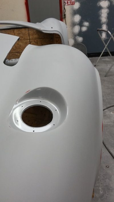 A close up of a white car with a hole in the middle