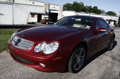 A red sports car is parked in front of a building
