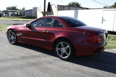 A red sports car is parked on the side of the road