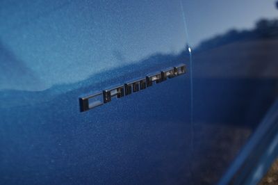 A close up of the emblem on the side of a blue car
