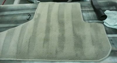 A beige floor mat is sitting on top of a table