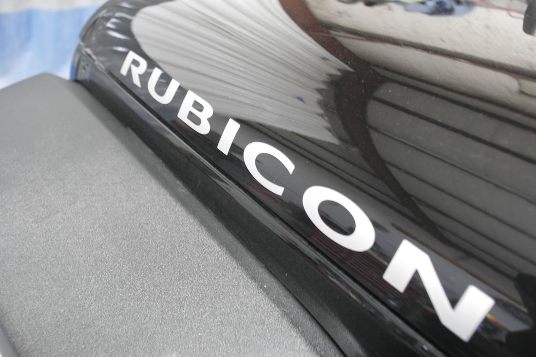 The word rubicon is on the side of a black car