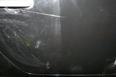 A close up of a car door with a scratch on it