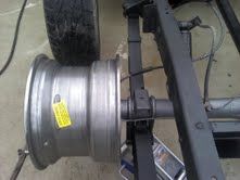 A close up of a wheel on a truck frame