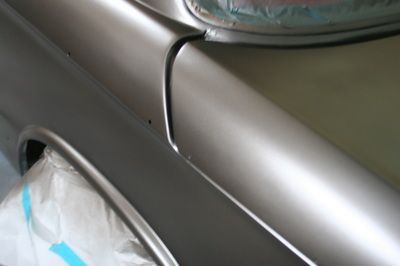 A close up of a car 's fender being painted