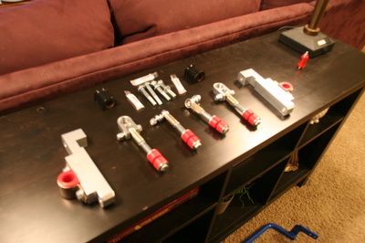 A bunch of tools on a table with a couch in the background