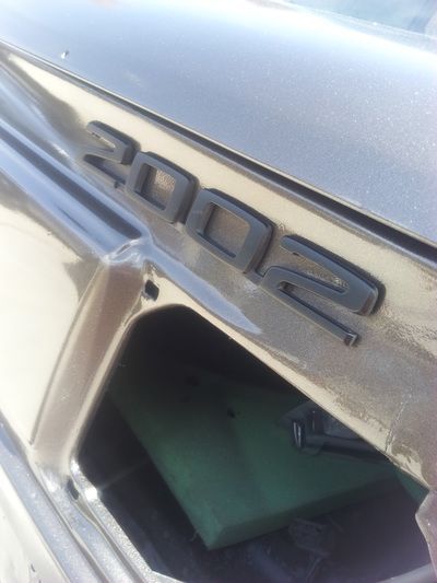 A close up of a 2002 emblem