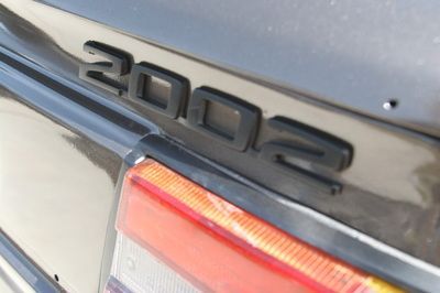 A black car with the year 2002 on the back