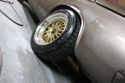 A close up of a car wheel with gold rims