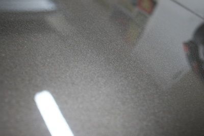 A close up of a shiny surface with a lot of small dots on it