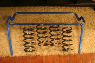 A bunch of springs are sitting on top of a wooden floor