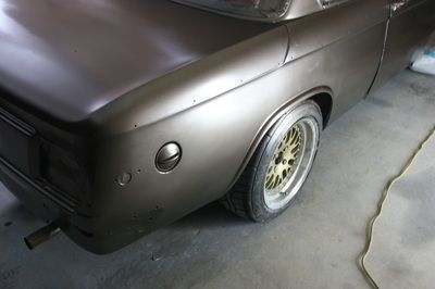 A close up of a car 's fender in a garage