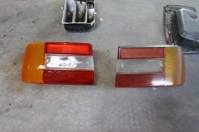 A pair of tail lights are sitting on a concrete surface