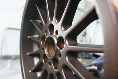 A close up of a car wheel with holes in it