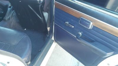 A close up of a car door with the door open