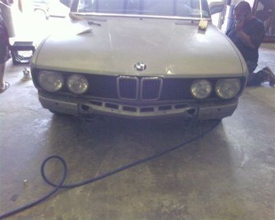 A bmw car is being worked on in a garage