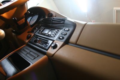 A close up of a car dashboard with a steering wheel