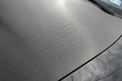 The hood of a car with the word garage written on it