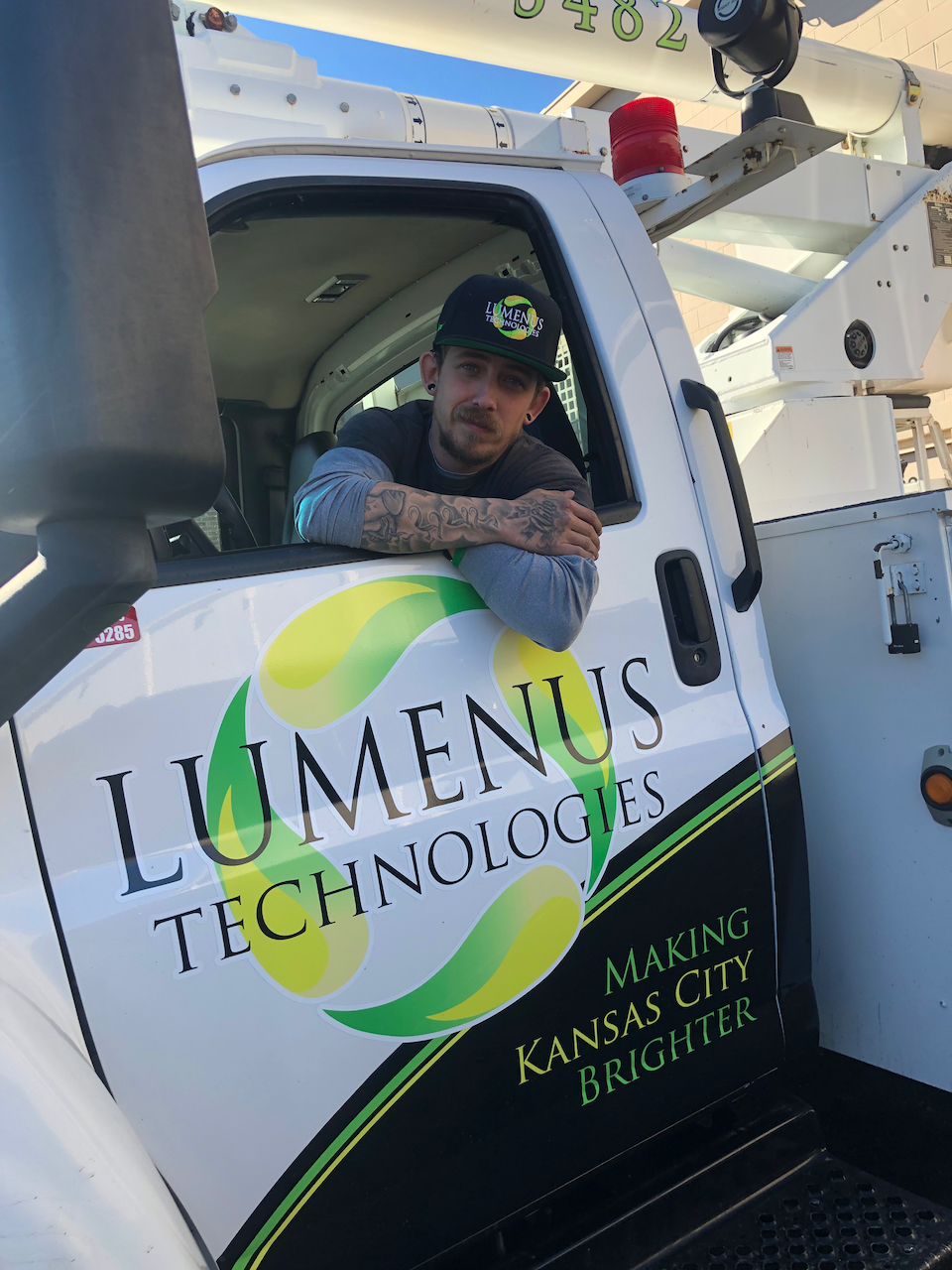 A man is sitting in the driver 's seat of a luminus technologies truck