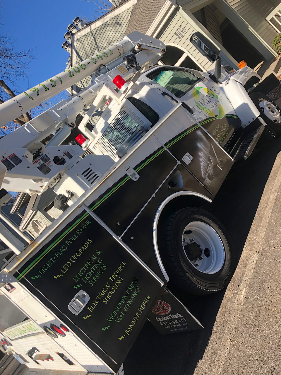 A black and white truck is parked on the side of the road.